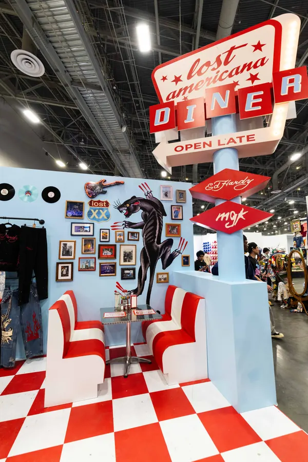 Diner booth seating and Ed Hardy x mgk signage at ComplexCon Las Vegas