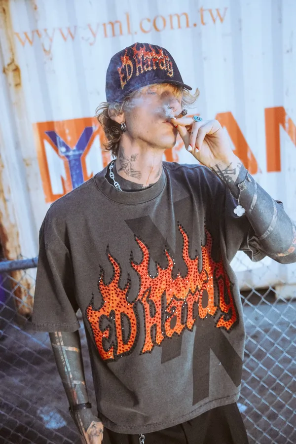 Ed Hardy x mgk flame logo tee and cap. Photo by Sam Cahill