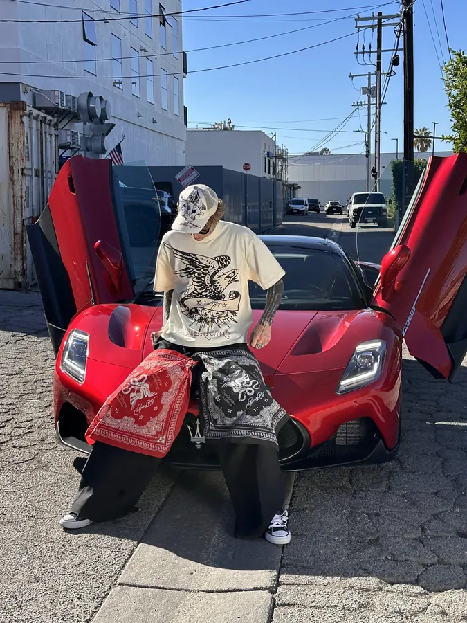 Ed Hardy x mgk lookbook: tee and bandana on a red supercar