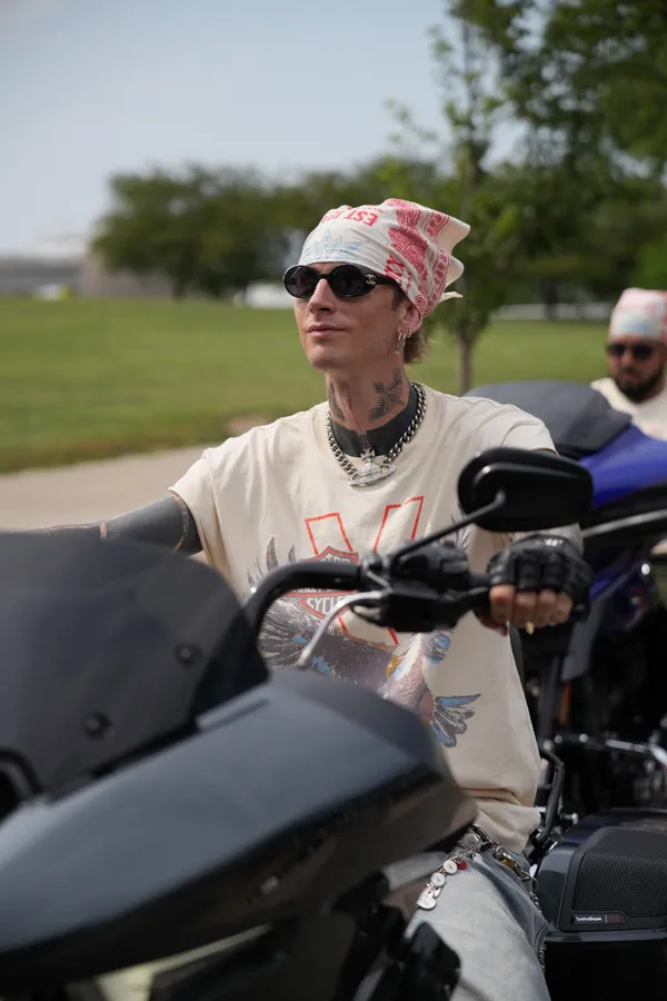 mgk riding in the Harley-Davidson x Lost Americana tee