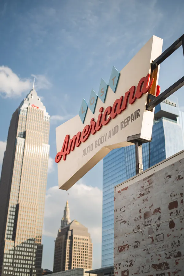 Americana Auto Body sign at the MGK Day block party, downtown Cleveland. Photo by Jacob Giampa
