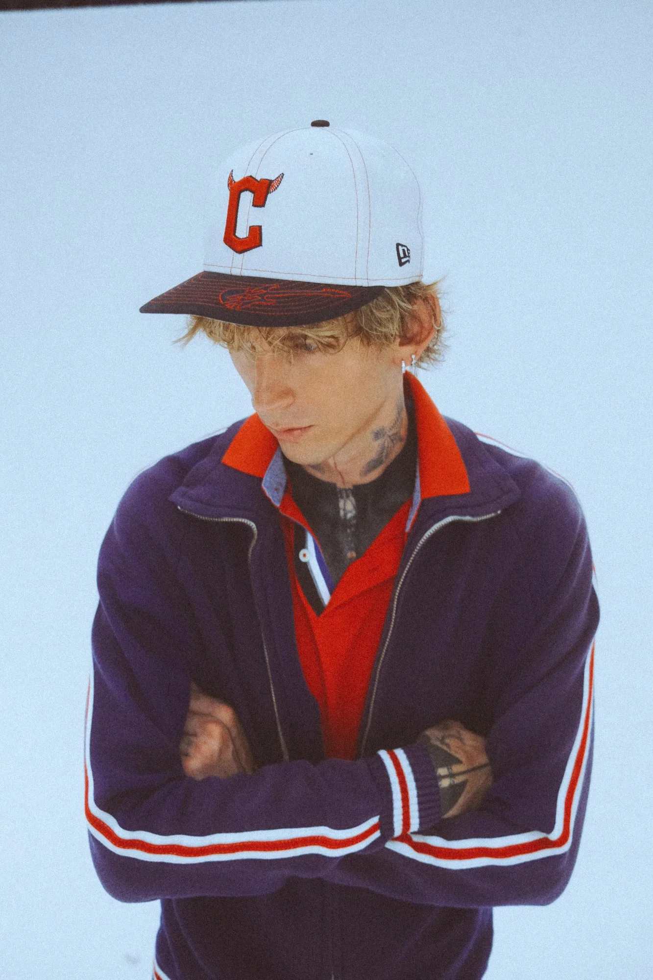 mgk in the Guardians track jacket and C cap. Photo by Sam Cahill