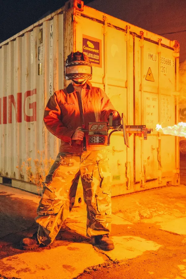PUBG x Floor 13 campaign: flamethrower burst in front of a shipping container. Photo by Sam Cahill